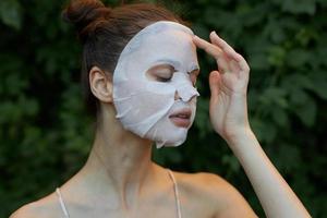 Beautiful woman Anti-wrinkle mask Closed eyes and transparent paper skin care leaves in the background photo