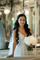 portrait of a bride in a white dress in a bright cafe photo