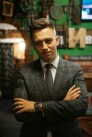 portrait of a groom in a gray plaid suit with a tie photo