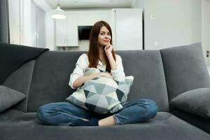 pretty woman with pillow in hands comfortable sofa interior leisure photo