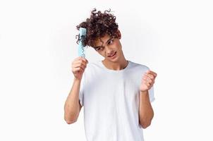 cheerful man in a white t-shirt comb hair curls emotions photo