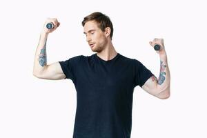 man with dumbbells muscles muscles bodybuilder fitness and tattoo on his arm photo