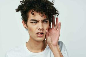 a guy in a white t-shirt has poor hearing health problems photo