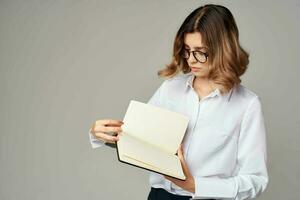 Business woman with notepad in hands professional office official photo