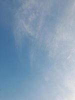 Beautiful white clouds on deep blue sky background. Large bright soft fluffy clouds are cover the entire blue sky. photo