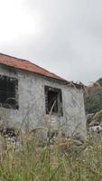 Abandoned simple stone building isolated in a field video