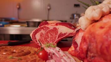 Raw t-bone beef ribeye steak on the table in butchery. video