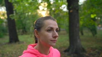 Close up of woman running through an autumn park at sunset video