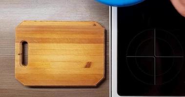 Technique of slicing potatoes on a wooden Board, top view. video