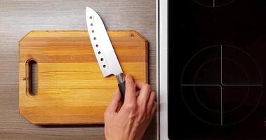 Technique of slicing onions on a wooden Board, top view. video