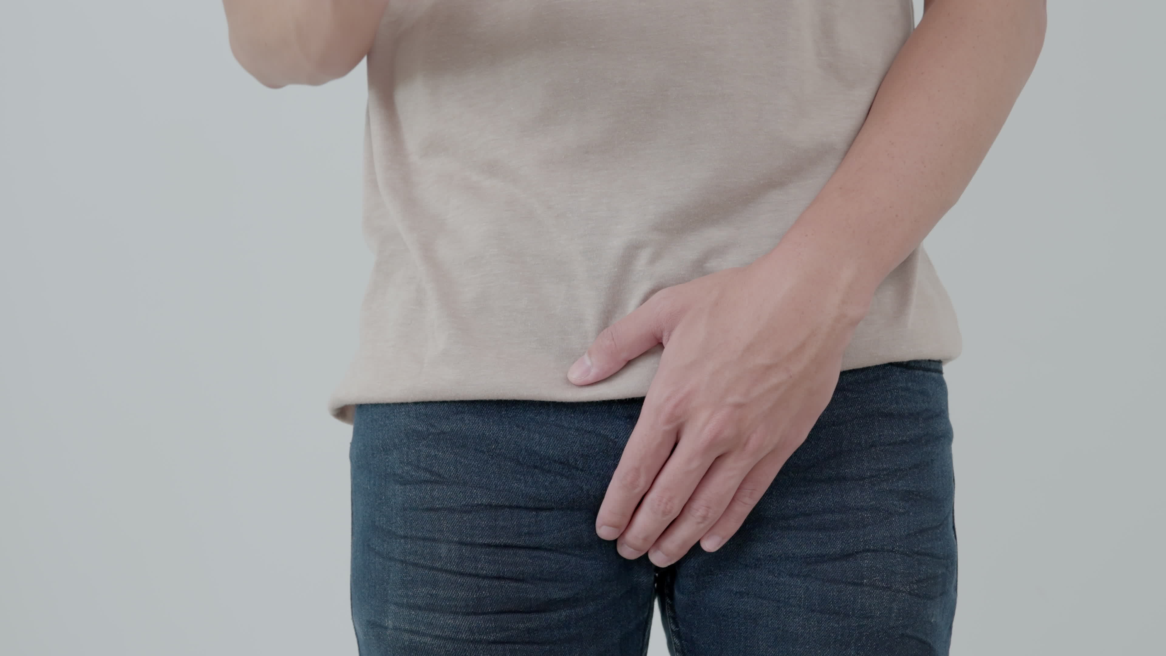 Man hold hand in front of private parts feeling from disease