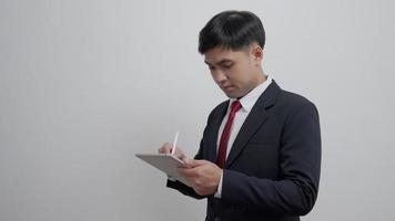 working man, Portrait of smiling Asia male in work clothes using tablet, at office and doing research, copy space, happy cheerful cute business, positive energy, Business plan, men executive video