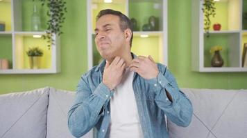 Man with allergic condition itches severely. A man with an allergy or disease itches at home, his body is irritated. video