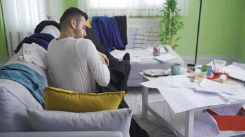 Lazy young man in messy and dirty house. Man with a lazy and disorderly lifestyle. video