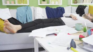 Lazy man sleeps at home and leads a messy and untidy home. The depressed man's house is messy, he sleeps all the time, he is lazy, he gets dirty. video