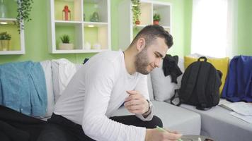 Messy and lazy man bored at home, distracted. Man working from home has a lazy, messy, disorganized lifestyle. video