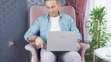 Man Connecting Plug To Electrical Outlet. Energy concept. Man plugging into electrical outlet to charge laptop at home. video