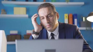Close-up portrait of thoughtful businessman working with laptop in office. Portrait of focused thoughtful serious businessman taking important steps in business. video