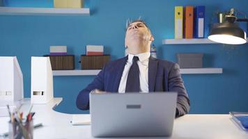 Stressed businessman working at computer with painful emotions suffering from eye strain. Office worker analyzing plans and strategy, tired from work, has a headache, stressed, needs a break. video