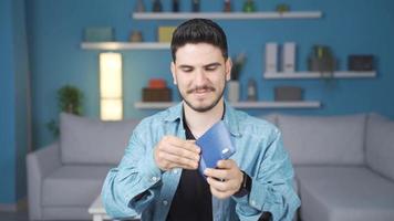 A well-to-do young man. The young man who takes his money out of his wallet counts and is happy. video