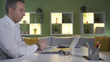 Happy man satisfied with smart home systems. The man increases or decreases the brightness of the house lights with smart system control from the phone. video