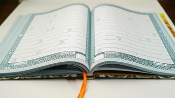 The Holy Quran with arabic calligraphy inscription with an open page photo
