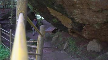 Man walking on the cave that popular travel destination on Semarang Central Java. The photo is suitable to use for adventure content media, nature poster and forest background. video