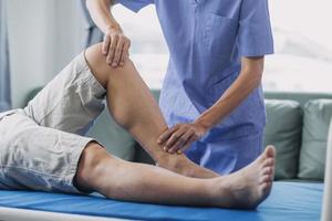 Doctor or Physiotherapist working examining treating injured arm of athlete male patient, stretching and exercise, Doing the Rehabilitation therapy pain in clinic. photo