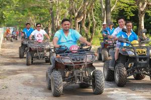 NAKHONNAYOK, THAILAND - DECEMBER 19 Tourists riding ATV to nature adventure on dirt track on DECEMBER 19, 2015, Thailand. photo