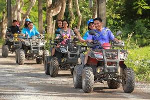 NAKHONNAYOK, THAILAND - DECEMBER 19 Tourists riding ATV to nature adventure on dirt track on DECEMBER 19, 2015, Thailand. photo