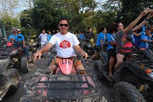 NAKHONNAYOK, THAILAND - DECEMBER 19 Tourists riding ATV to nature adventure on dirt track on DECEMBER 19, 2015, Thailand. photo