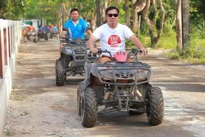 NAKHONNAYOK, THAILAND - DECEMBER 19 Tourists riding ATV to nature adventure on dirt track on DECEMBER 19, 2015, Thailand. photo