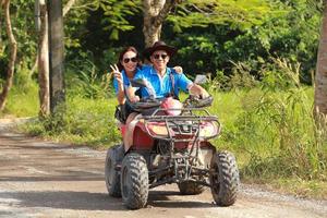 NAKHONNAYOK, THAILAND - DECEMBER 19 Tourists riding ATV to nature adventure on dirt track on DECEMBER 19, 2015, Thailand. photo