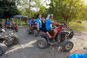 NAKHONNAYOK, THAILAND - DECEMBER 19 Tourists riding ATV to nature adventure on dirt track on DECEMBER 19, 2015, Thailand. photo