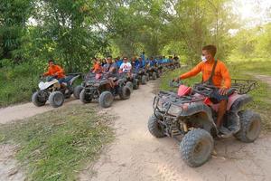 NAKHONNAYOK, THAILAND - DECEMBER 19 Tourists riding ATV to nature adventure on dirt track on DECEMBER 19, 2015, Thailand. photo