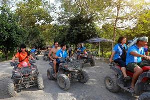 NAKHONNAYOK, THAILAND - DECEMBER 19 Tourists riding ATV to nature adventure on dirt track on DECEMBER 19, 2015, Thailand. photo