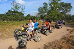 NAKHONNAYOK, THAILAND - DECEMBER 19 Tourists riding ATV to nature adventure on dirt track on DECEMBER 19, 2015, Thailand. photo