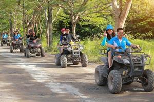 NAKHONNAYOK, THAILAND - DECEMBER 19 Tourists riding ATV to nature adventure on dirt track on DECEMBER 19, 2015, Thailand. photo