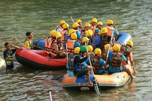 NAKHONNAYOK, THAILAND,DECEMBER 19  Group of adventurer doing white water rafting at dam, on December 19, 2015,The river is popular for its scenic nature view. photo