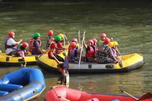 NAKHONNAYOK, THAILAND,DECEMBER 19  Group of adventurer doing white water rafting at dam, on December 19, 2015,The river is popular for its scenic nature view. photo