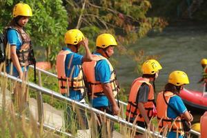 NAKHONNAYOK, THAILAND,DECEMBER 19  Group of adventurer doing white water rafting at dam, on December 19, 2015,The river is popular for its scenic nature view. photo