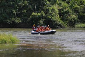 NAKHONNAYOK, THAILAND,DECEMBER 19  Group of adventurer doing white water rafting at dam, on December 19, 2015,The river is popular for its scenic nature view. photo