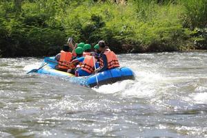 NAKHONNAYOK, THAILAND,DECEMBER 19  Group of adventurer doing white water rafting at dam, on December 19, 2015,The river is popular for its scenic nature view. photo