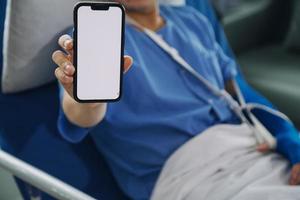 Injured patient showing doctor broken wrist and arm with bandage in hospital office or emergency room. Sprain, stress fracture or repetitive strain injury in hand. Nurse helping customer. First aid. photo