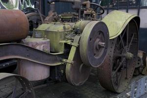 antique metal car forming a mechanical background in a museum photo