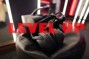 Level up concept. Professional headphones with microphone and vr glasses for video games and cyber sports on background. photo