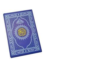 Holy Al Quran with written arabic calligraphy on white background with copy space photo