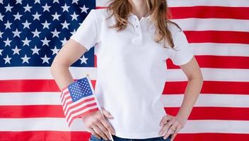 White polo shirt on woman over USA flag background, mockup design photo