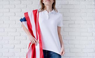 White polo shirt on woman over USA flag background, mockup design photo