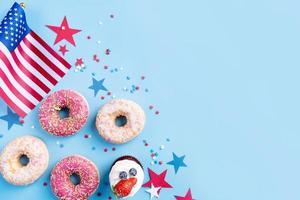 Sweet cupcakes and donuts with usa flag on blue background photo